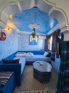 a living room with blue walls and a blue ceiling at dar lalla chafia 1 studio triplex in Chefchaouene