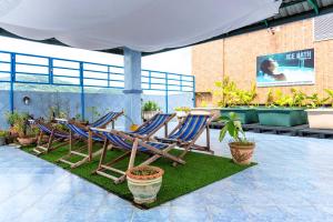 a group of lawn chairs sitting on a patio at Hua Hin Loft in Hua Hin