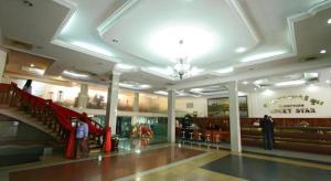 a large shopping mall with people standing in the lobby at Lucky Star Hotel in Phnom Penh