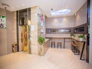 a large room with a kitchen with a counter at GreenTree Alliance Shenzhen Shekou Sea World Hotel in Shenzhen