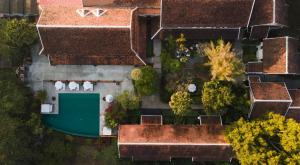 an overhead view of a house with a green garage at La Résidence Phou Vao in Luang Prabang