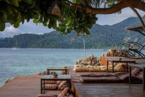 a wooden pier with a view of the water at DECHO BEACH RESORT in Ko Lipe