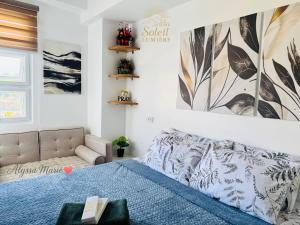 Ένα ή περισσότερα κρεβάτια σε δωμάτιο στο Soleil Lumière - Stanford Residences Baguio City