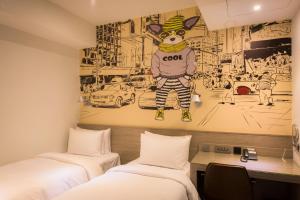 Postel nebo postele na pokoji v ubytování Legend Hotel Kaohsiung Pier2