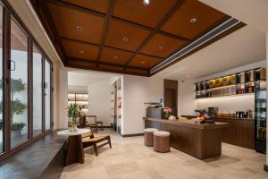 a lobby with a counter and a kitchen at Jiuhua Goodstay Inn in Chizhou