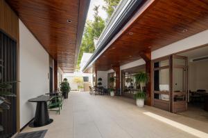 an internal courtyard of a building with tables and chairs at Jiuhua Goodstay Inn in Chizhou