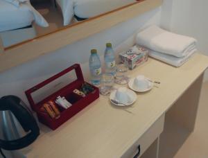 a table with a tray of food and bottles of water at Vilu Himmafushi in Himmafushi