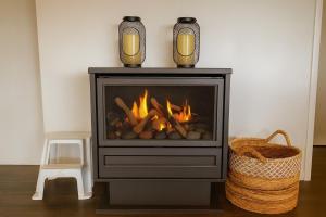 Hibiscus Haven 1BR getaway in Valla Beach في Valla Beach: مدفأة عليها مزهرين +صورتان