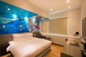 Postel nebo postele na pokoji v ubytování Legend Hotel Kaohsiung Pier2