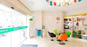 a room with chairs and a table and a chandelier at GreenTree Inn Shanghai Guangxin Road Tongji Hospital Express Hotel in Shanghai