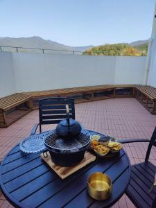 a table with a hat and bowls of food on a balcony at Huazhu Xiangshan Tongchen Courtyard in Xiangshan