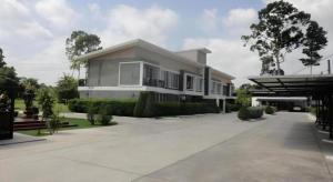 a large house with a driveway in front of it at Loft Village in Ban Khlong Kathon