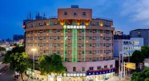 a large building with a clock on the side of it at GreenTree Inn Anqing Renmin Road Commercial Street Express Hotel in Anqing