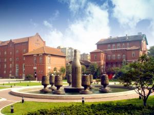 a fountain in a park in front of a building at Qingdao Blue Horizon Hotel Laoshan in Qingdao