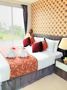 a bedroom with a bed with two swans on it at The Wings Boutique Hotels Krabi Ko Lanta in Ko Lanta