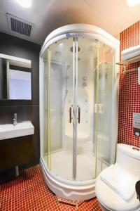 a shower in a bathroom with a toilet and a sink at Metroplace Olympic in Hong Kong +157 photos