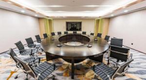 a conference room with a large table and chairs at Shunshine International Hotel Xiangxi in Ganziping
