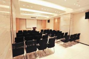 a conference room with black chairs and a whiteboard at City Comfort Inn Wuhan Wansongyuan Wangjiadun East Metro in Wuhan