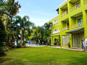 a view of a building with a yard at Hotel Camila 2 in Dipolog