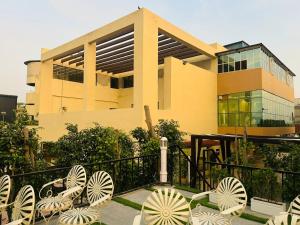 a building with a bunch of white chairs in front of it at Florian Club Resort and Spa Jaipur in Jaipur