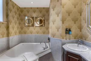 a bathroom with a tub and a sink at The Fort Garry Hotel, Spa and Conference Centre, an Ascend Collection Hotel in Winnipeg +132 photos