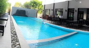 a large blue swimming pool next to a building at The Palm Hotel in Sihanoukville +144 photos