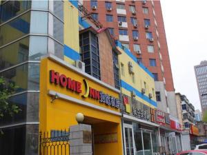 a store with a home invasion sign in a city at Home Inn Shijiazhuang West Zhongshan Road Jinding Apartment in Shijiazhuang