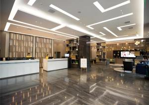 a lobby with a reception desk in a building at City Comfort Inn Wuhan Huangpu in Wuhan