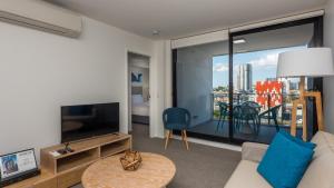a living room with a couch and a large window at Annexe Apartments in Brisbane