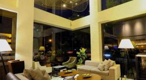 a living room with couches and tables in a building at Home Crest Hotel in Sanghay