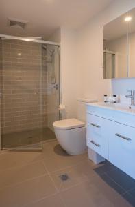 a bathroom with a toilet, sink, and shower at Annexe Apartments in Brisbane