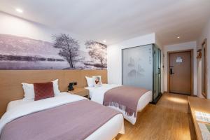 Ένα ή περισσότερα κρεβάτια σε δωμάτιο στο Mushanxun Hotel Changsha Yuelushan Orange Isle Branch +41 φωτογραφίες