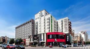 a large building on a city street with cars at Yitel Collection Shenyang Imperial Palace Zhongjie Metro Station in Shenyang