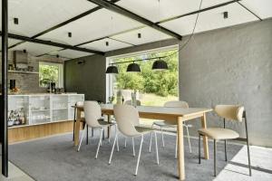 a kitchen and dining room with a table and chairs at Fjord-Close Cottage With Beautiful View in Hemmet