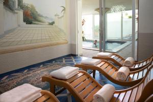 a room with chairs and a swimming pool in a building at Hotel Orizzonte in Bellaria-Igea Marina +23 photos