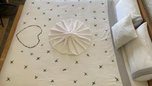 a white bed with black stars on it at Grand canyon domes Jabal shams in Sa‘ab Banī Khamīs +20 photos