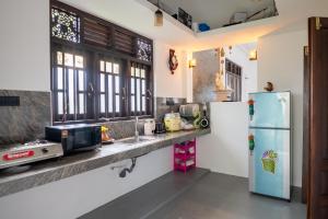 a kitchen with a sink and a refrigerator at Villa Sky View Hikka in Hikkaduwa +37 photos