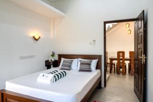 a bedroom with a bed and a dining room at Villa Sky View Hikka in Hikkaduwa