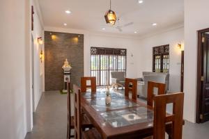 a dining room with a table and chairs at Villa Sky View Hikka in Hikkaduwa