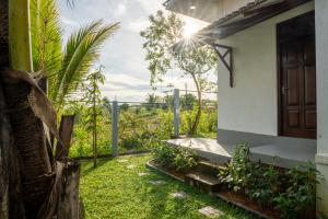 a door of a house with a grass yard at Villa Sky View Hikka in Hikkaduwa