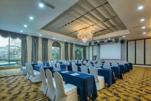 a large banquet hall with blue tables and white chairs at New Century Manju Hotel Shanghai New International Expo Center in Shanghai