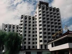 a large white building with a clock on top of it at Chengde Yunshan Hotel in Chengde