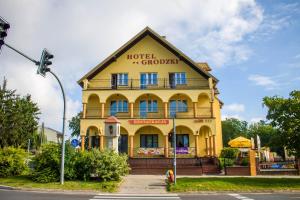 a yellow building with a sign on it at Hotel Grodzki in Sandomierz