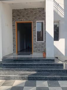 a house with stairs leading to a door at Star Amaya Homestay River Side Mountain and Forest View in Kangra Airport