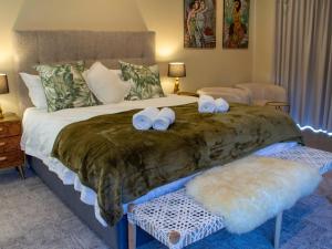 a bedroom with a large bed with towels on it at IL Gattopardo in Wilderness