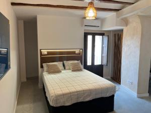 a bedroom with a large bed in a room at Les Cases de Laia in Bocairent