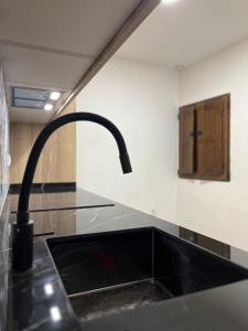 a kitchen with a sink and a faucet at Les Cases de Laia in Bocairent +31 photos