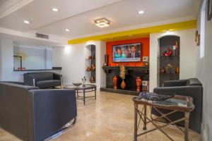 a living room with two chairs and a tv at Rodeway Inn Near Ybor City - Casino in Tampa