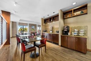 a dining room and kitchen with a table and chairs at Comfort Inn & Suites West - Medical Center in Rochester