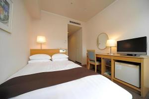 Ένα ή περισσότερα κρεβάτια σε δωμάτιο στο Green Hill Hotel Onomichi